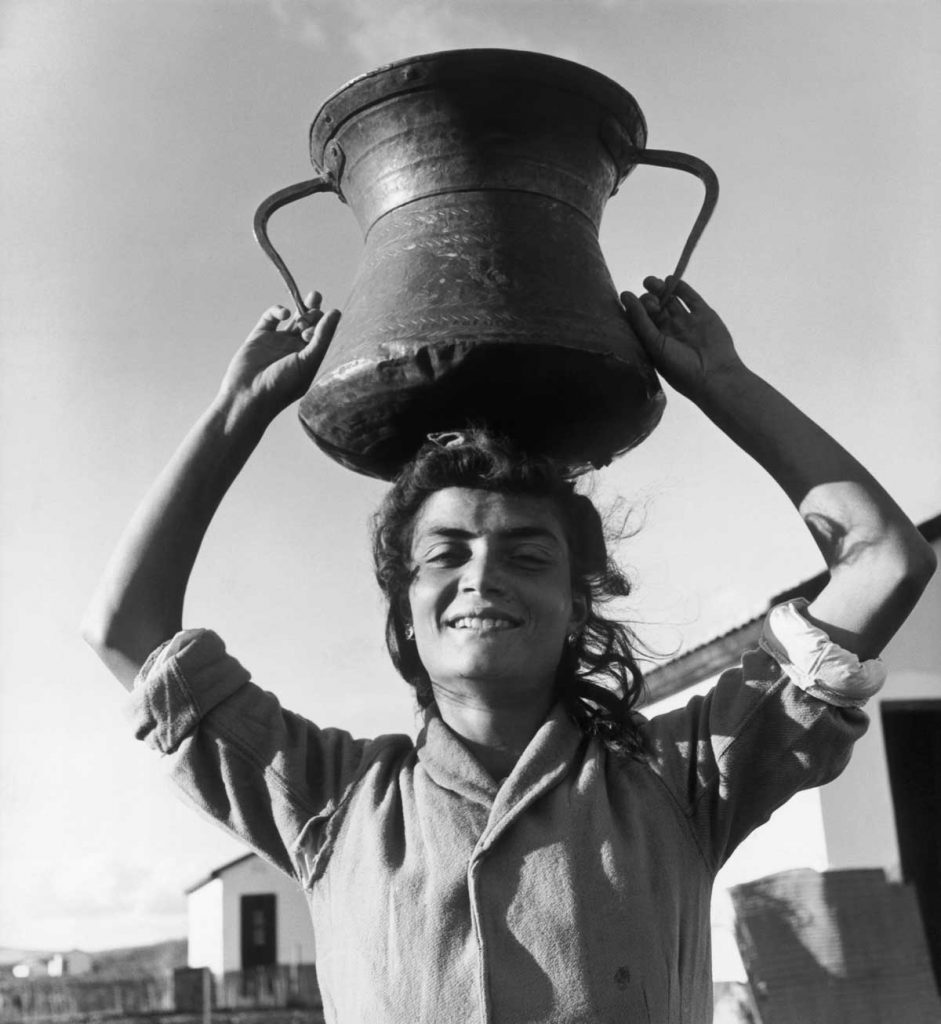 Water is scarce and has to be carried from a neighbouring reservoir. The brass water jug is being carried by Ruth Bonfitto, formerly Adelina, in the customary manner of the peasants of San Nicandro where it was brought from. 1951.